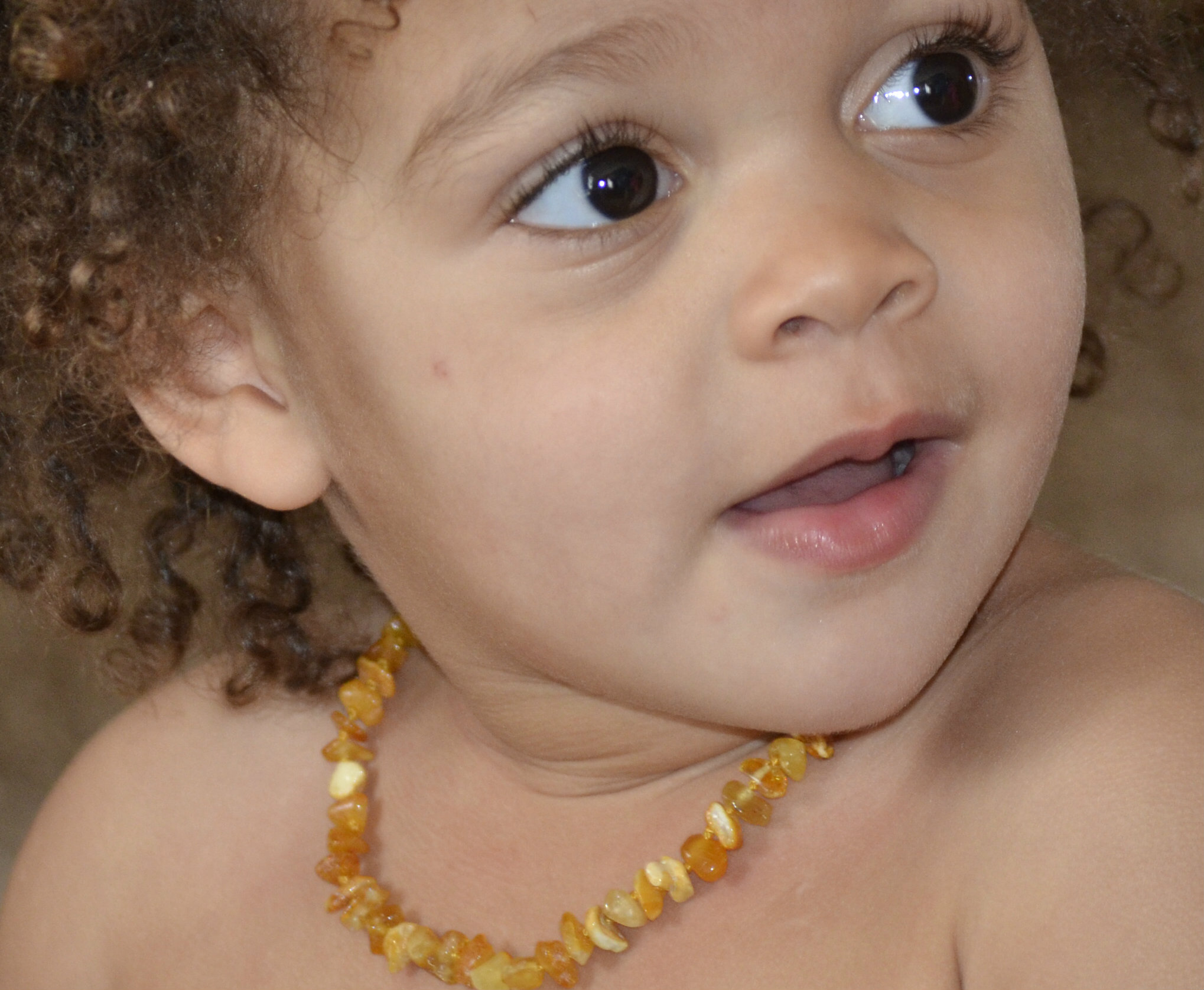 Baby wearing amber teething necklace